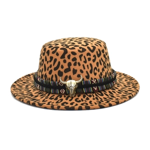 Detail of leopard print flat top hat with ethnic ribbon and vintage bull skull pendant