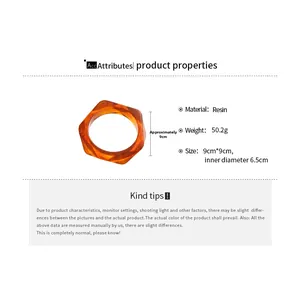 Macro detail of hexagonal resin bracelet showing amber tortoiseshell texture and dimensions