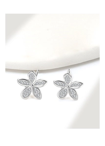 Macro shot of silver flower earrings with delicate micro-paved sparkling zircon stones