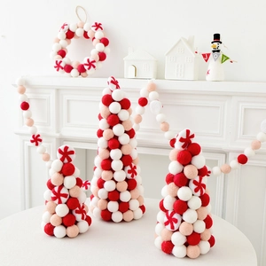 Felt wool Christmas tree and garland set with red and white pom poms for festive tabletop decor