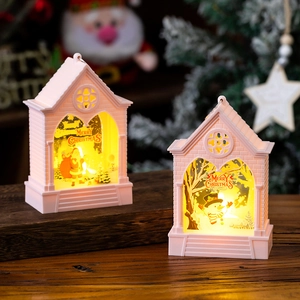 Close-up of pink Christmas lantern house with warm LED lighting and Santa scene decor