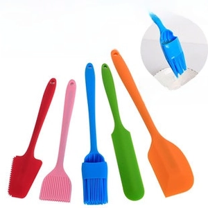 Detailed set of colorful heat-resistant silicone baking tools including spatulas and oil brushes