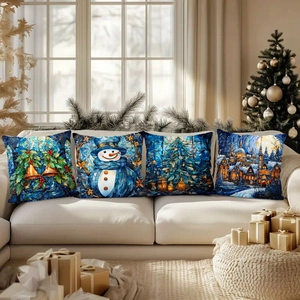 Detail of four festive Christmas pillow covers with stained glass art on a cozy sofa
