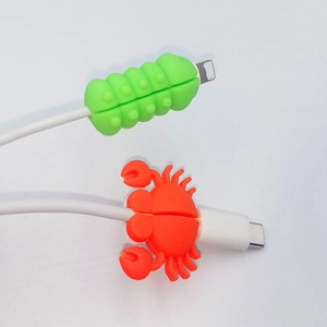 Silicone animal cable protectors in green insect and orange crab shapes for cable protection