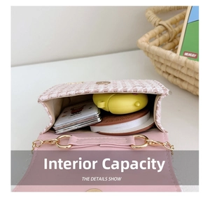 Detail showing the inner capacity of the pink tweed crossbody bag with metal magnetic snap