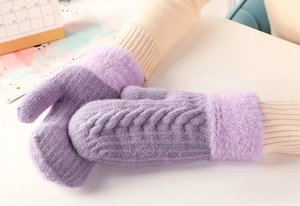 Detail of purple cable knit mittens featuring soft faux fur trim for winter warmth