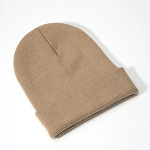 Macro view of solid camel knit beanie showing refined ribbed texture and wide cuffed brim