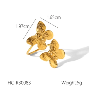 Detail view of gold butterfly ring showing dimensions of 1.97cm and polished texture