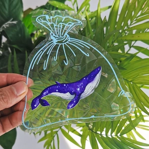 Detailed view of rainbow suncatcher sticker featuring a blue whale in a bag design