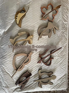 Macro shot of 8 animal-shaped wooden brooch pins showing natural wood grain and laser-cut edges