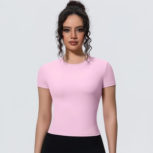 Close-up of pink slim-fit yoga top with breathable quick-dry fabric and ergonomic seams