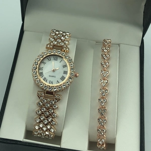 Detail of rose gold diamond watch and heart bracelet set in a black gift box