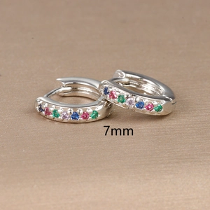 Macro view of 7mm silver hoop earrings featuring colorful cubic zirconia inlay stones