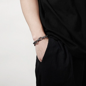 Detail of masculine gunmetal chain bracelet with industrial rotating spring clasp