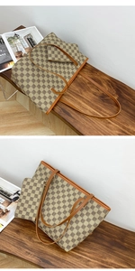 Detail view of two-piece tote bag set with geometric monogram print on a wooden bench