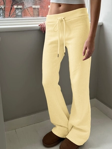 Close-up of light yellow yoga sweatpants featuring a soft cotton fabric and drawstring waist