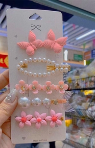 Five-piece candy-colored butterfly hair clip set with pearls and floral motifs on card