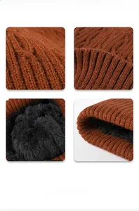Detail of caramel knit beanie showing thick black fleece lining and cable stitch texture