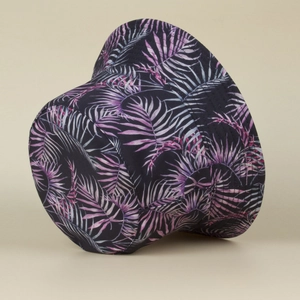 Close-up of black sun hat with purple and pink palm leaf pattern in tropical style
