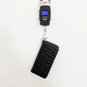 Black long PU leather zipper wallet for women featuring wavy quilting and 130g lightweight