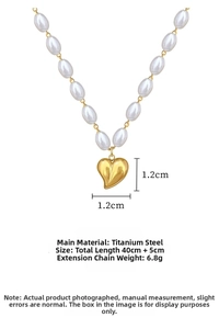 Detail showing a 1.2cm gold heart pendant on a premium pearl necklace made of titanium steel