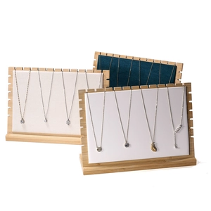 Bamboo necklace display stands with premium white and dark green velvet surfaces