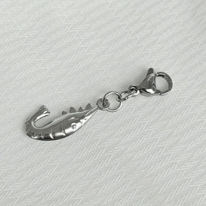 Detailed view of silver stainless steel lobster clasp pendant on textured white background