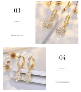 Detail of s925 silver flower and clover earrings with gold plating and cubic zirconia