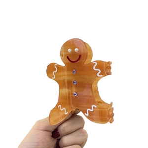 Gingerbread man hair claw clip made of brown acetate with pearls and purple rhinestones