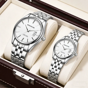 Close-up of elegant couple watches with white dials in a brown leather gift box
