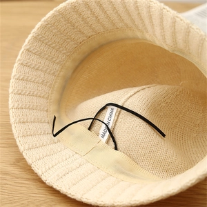 Close-up of knit bucket hat interior with sweatband, adjustable drawstring and texture