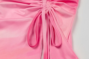 Detailed macro view of pink ruched fabric texture with adjustable drawstring ties
