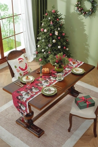 Close-up of red Christmas table runner with snowman pattern and festive tassels