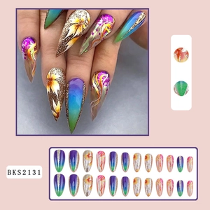 Detailed view of long almond press-on nails with colorful glitter and floral patterns