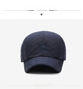 Close-up of diamond quilted texture and embroidered logo on navy blue winter baseball cap