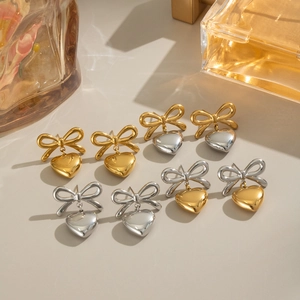 Elegant two-tone heart and bow drop earrings in gold and silver stainless steel