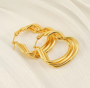 Macro shot of 18k gold plated stainless steel earrings with triple wave textures