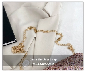 Detail of the golden metal chain strap and colorful glitter surface on a women crossbody bag