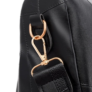 Detail of premium black lychee grain leather stitching and light gold metal lobster clasp