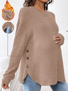 Detail view of maternity knit sweater with side buttons and warm fleece lining texture