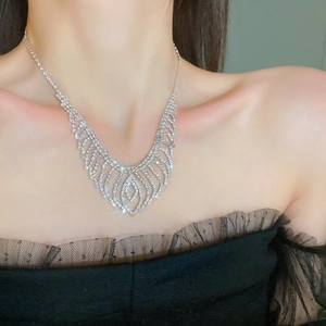 Close-up of sparkling rhinestone tassel necklace worn by a model for a luxury look