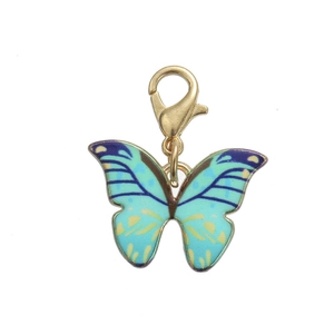 Detailed macro shot of a turquoise enamel butterfly charm with a gold lobster clasp