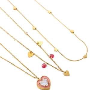 Gold star and heart necklace set featuring pink heart pendant on white background