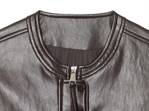 Detail of dark brown leather vest featuring a round neck and silver metal zipper