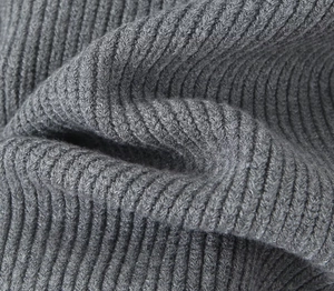 Macro shot of dark grey ribbed knit texture on a stylish American cardigan sweater