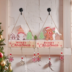 Detail of wooden Merry Christmas hanging ornaments with gnomes and red beads on white wall
