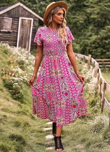 Détails de la robe longue fleurie rose avec bustier froncé et jupon à volants