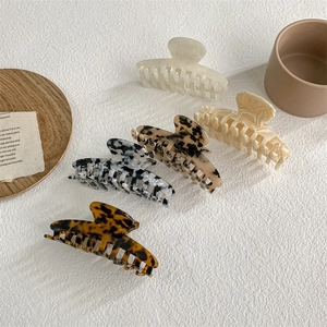 French style acetate hair claws set in pearl white, cream and tortoiseshell patterns