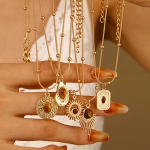Gold layered tiger eye pendant necklace with bohemian sun and teardrop charms for women