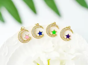 Macro view of 18K gold plated crescent moon and star charms with colorful enamel